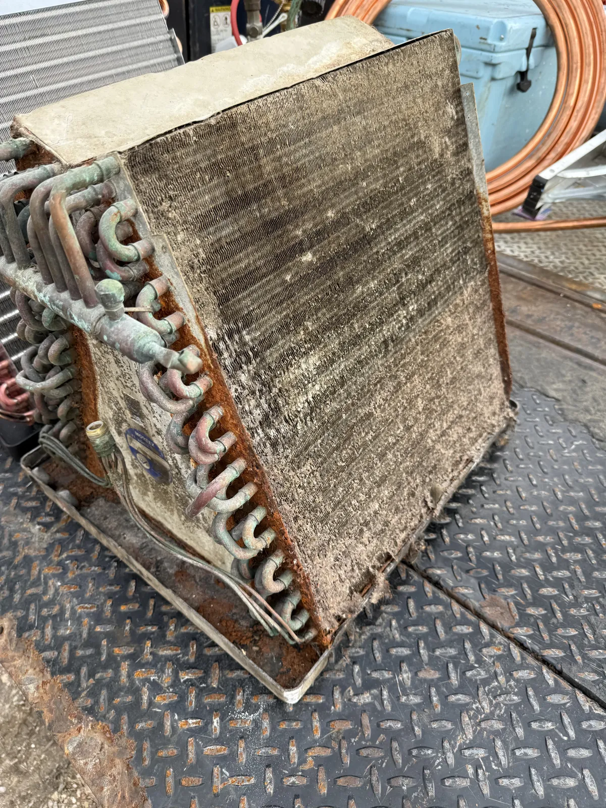 Corroded evaporator coil removed during an HVAC inspection